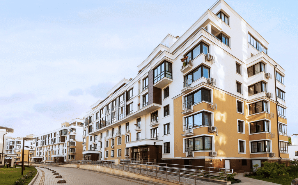 Modern multi-storey apartment building with balconies and a ramp walkway